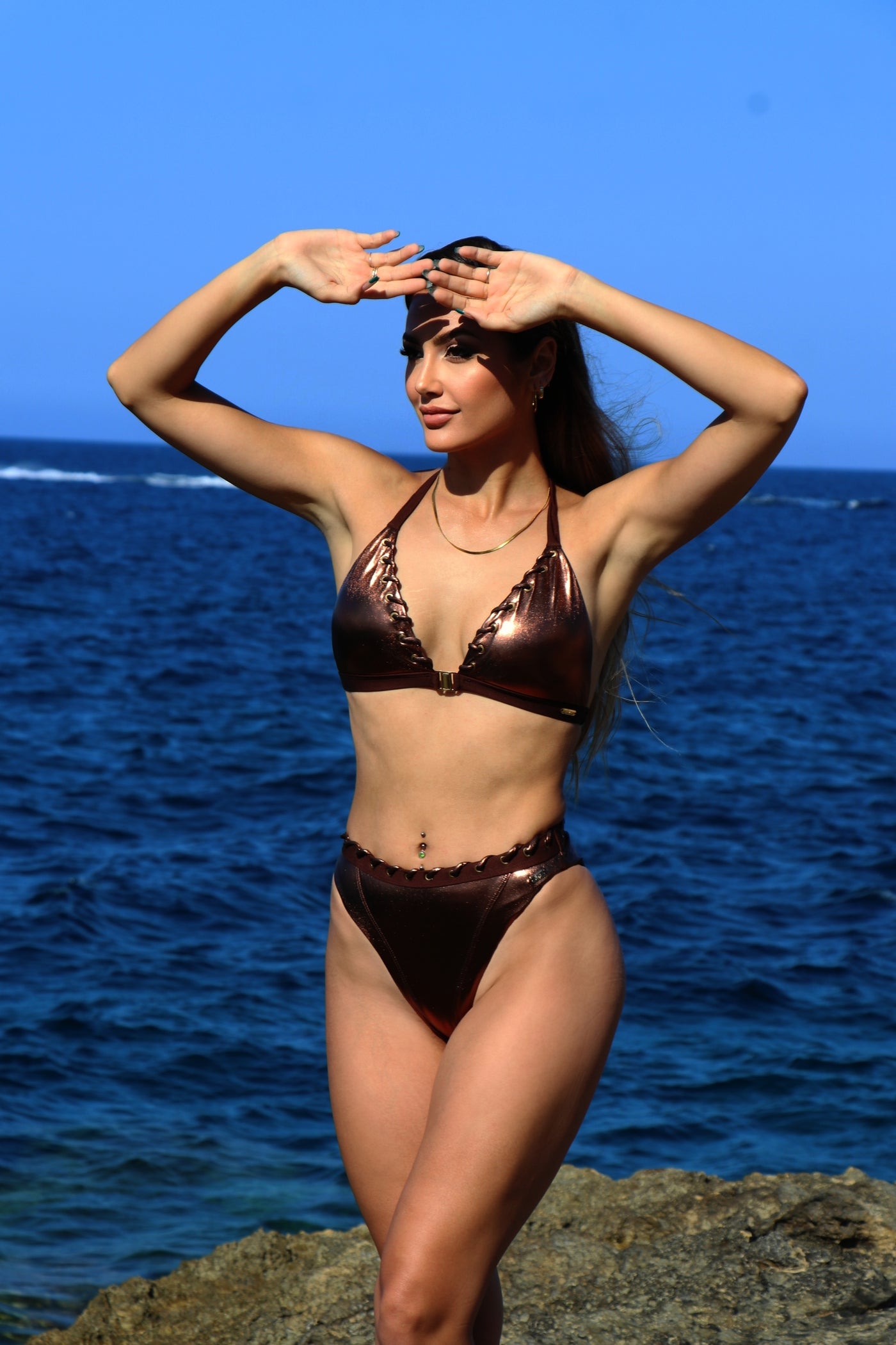 A woman wearing a high waisted bikini bottom