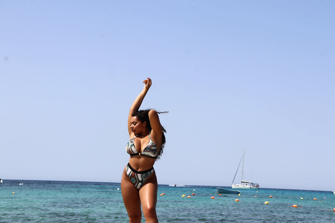 Woman wearing a bikini bottom with a high cut leg.