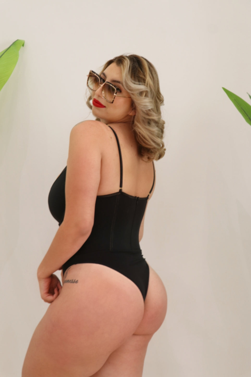 Woman wearing a medium coverage One Piece with adjustable straps in black